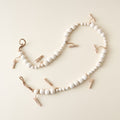 A wooden garland with small clothes pins clipped to it.