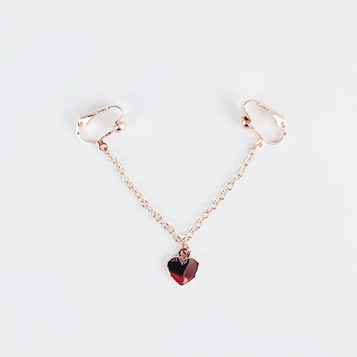 A rose gold labia chain dangle with a heart charm designed for non-piercing wear on the outer labia lips.
