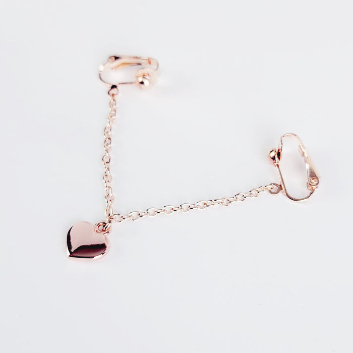 A rose gold labia chain dangle with a heart charm designed for non-piercing wear on the outer labia lips.