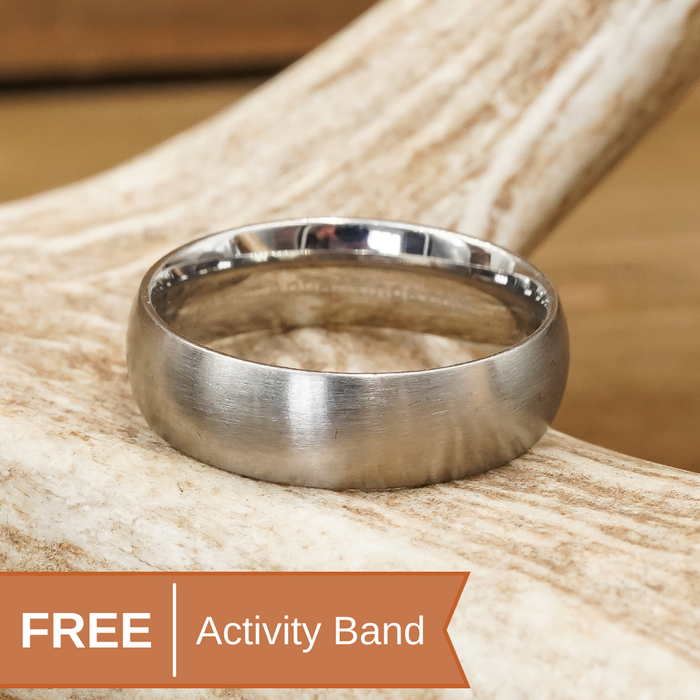 A silver-colored tungsten carbide ring, known as The Lane, rests on a light-colored antler. An orange banner at the bottom left reads “FREE Activity Band” in white and orange text.