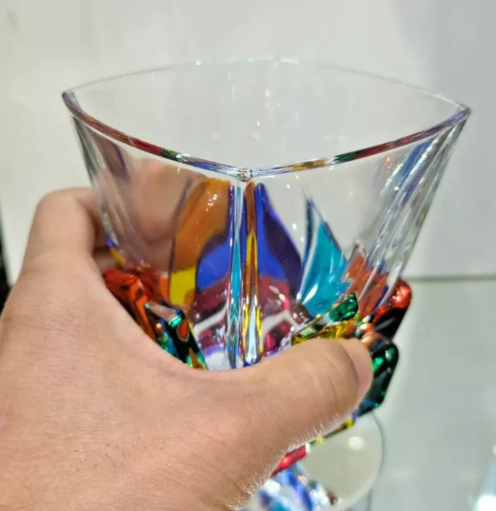 A whisky glass on hand.